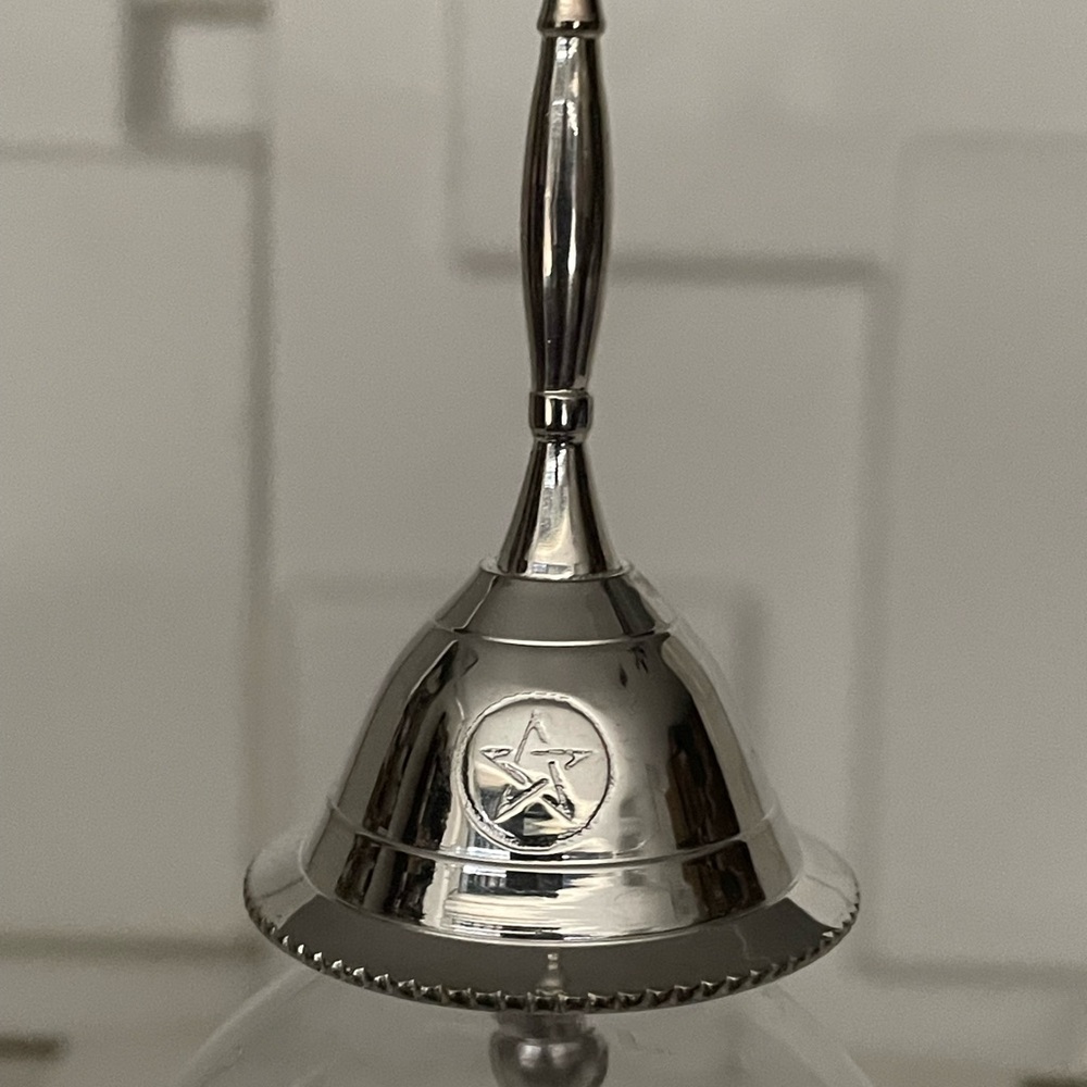 Elegant Silver Bell with Star Emblem